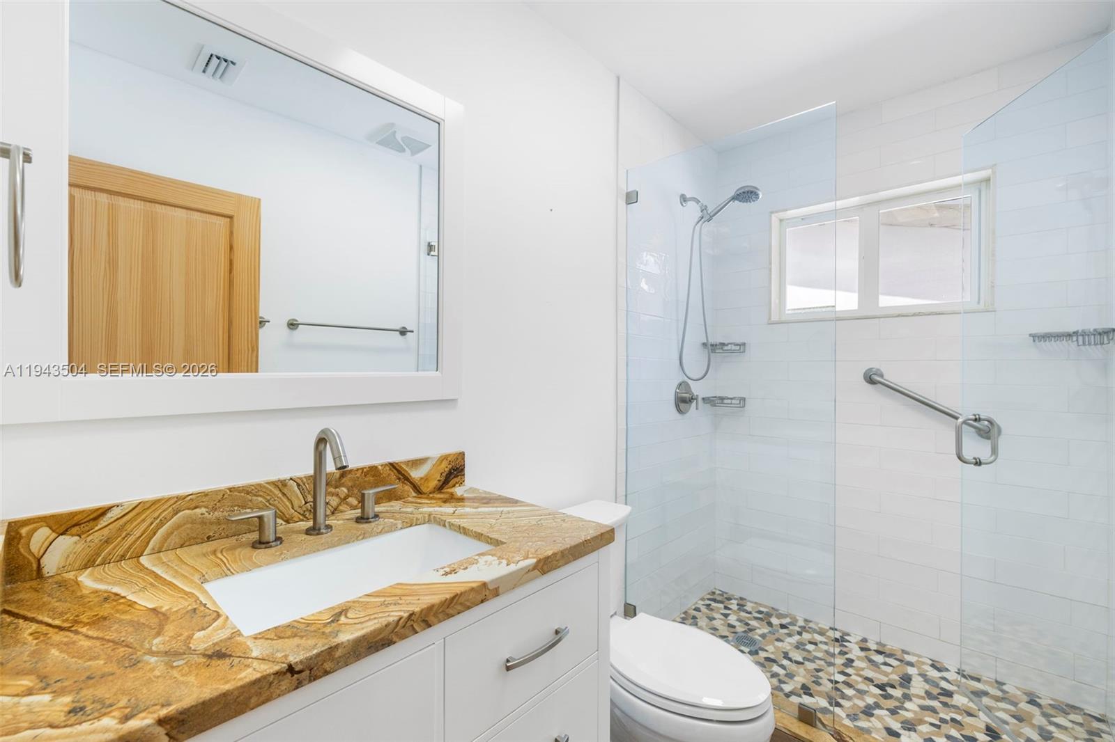 1895 Ixora Road North Miami, FL 33181 - Photo 28 of 42 a bathroom with a granite countertop sink toilet and shower