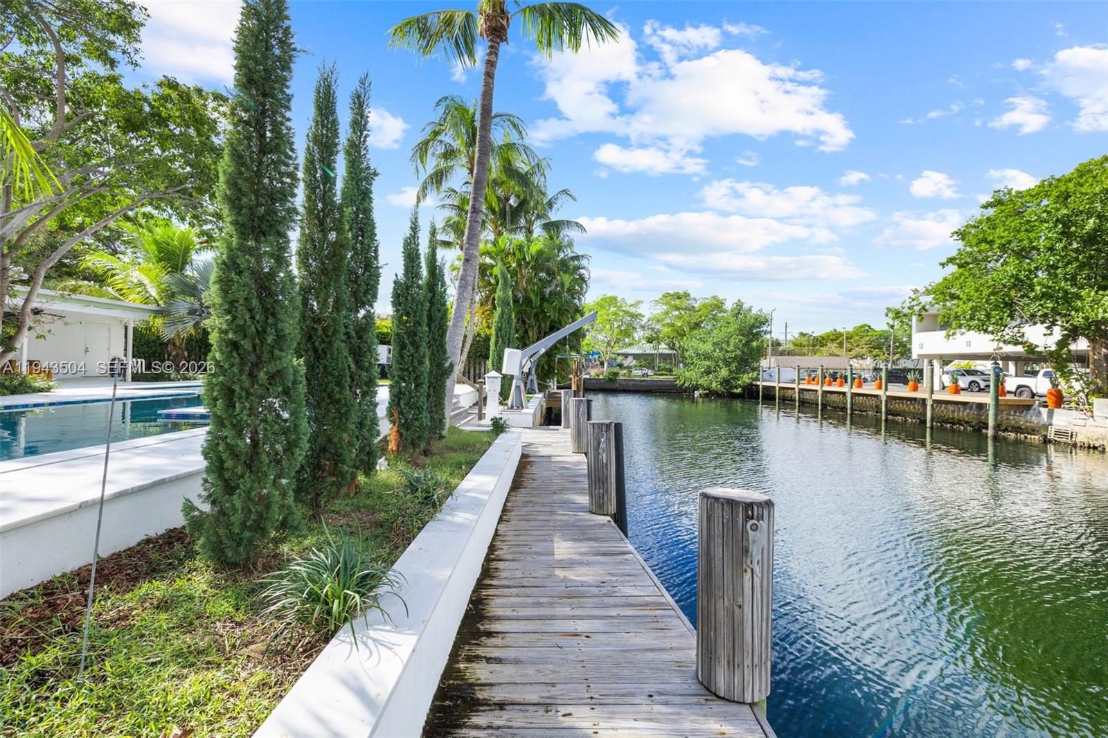 1895 Ixora Road North Miami, FL 33181 - Photo 3 of 42 a view of a lake with a house