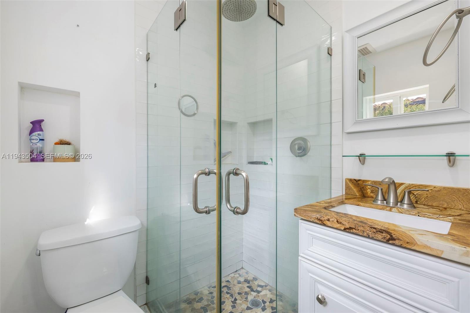 1895 Ixora Road North Miami, FL 33181 - Photo 31 of 42 a bathroom with a granite countertop shower sink vanity and toilet