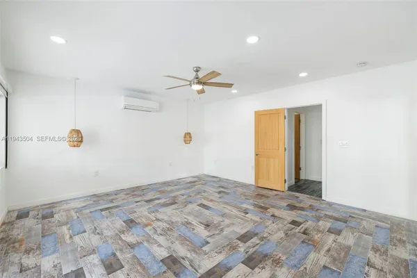 a view of a livingroom with a ceiling fan and window