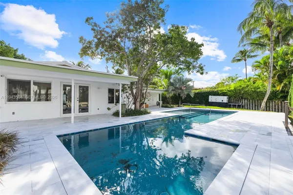 a view of a house with backyard and sitting area