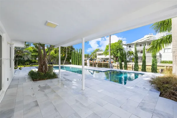 a view of swimming pool with an outdoor seating