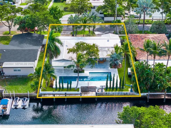 an aerial view of a house with a yard swimming pool a patio and yard