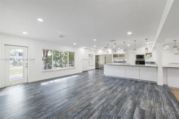a view of kitchen with kitchen island and stainless steel appliances