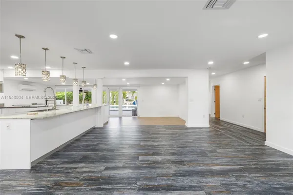 a view of kitchen with kitchen island and stainless steel appliances
