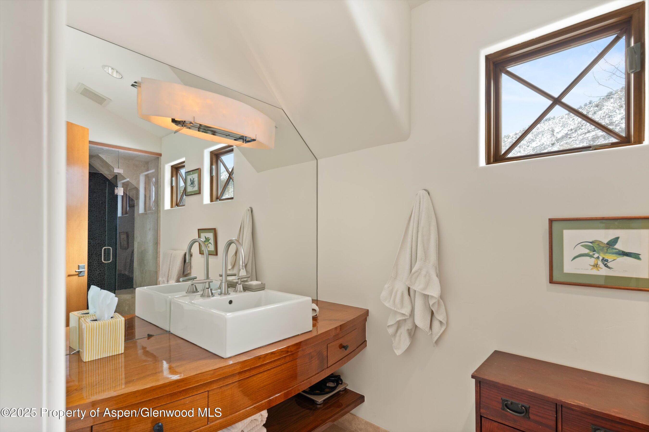 256 Twining Flats Road Aspen, CO 81611 - Photo 20 of 38 a bathroom with a sink and a mirror