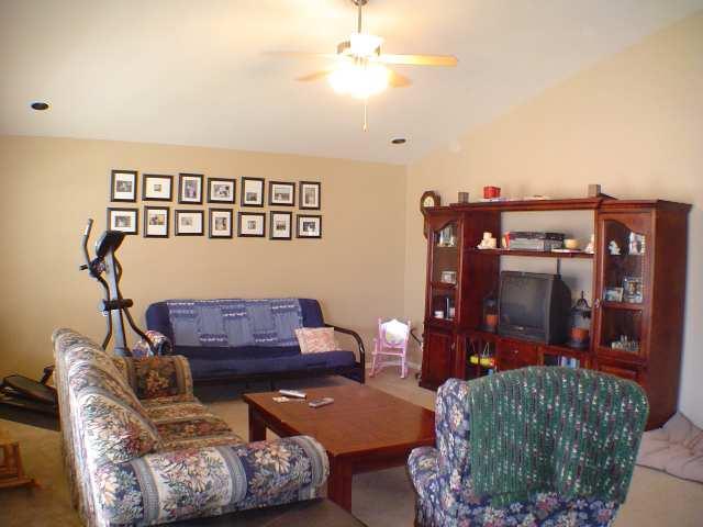324 Evergreen Drive Rifle, CO 81650 - Photo 4 of 9 a living room with furniture and a chandelier