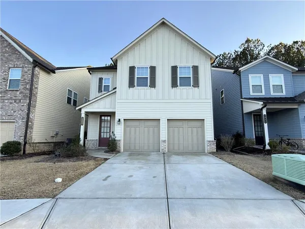 a view of a house with a yard and garage