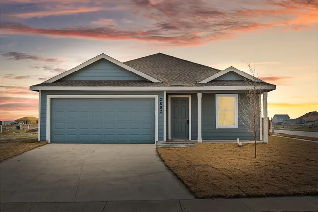 front view of a house with a yard
