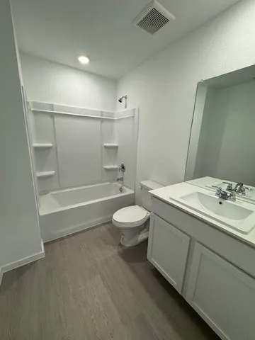 a bathroom with a toilet a sink and a bathtub
