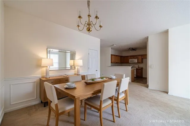 a view of a dining room with furniture and a chandelier