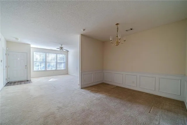 a view of an empty room with a fireplace and a window