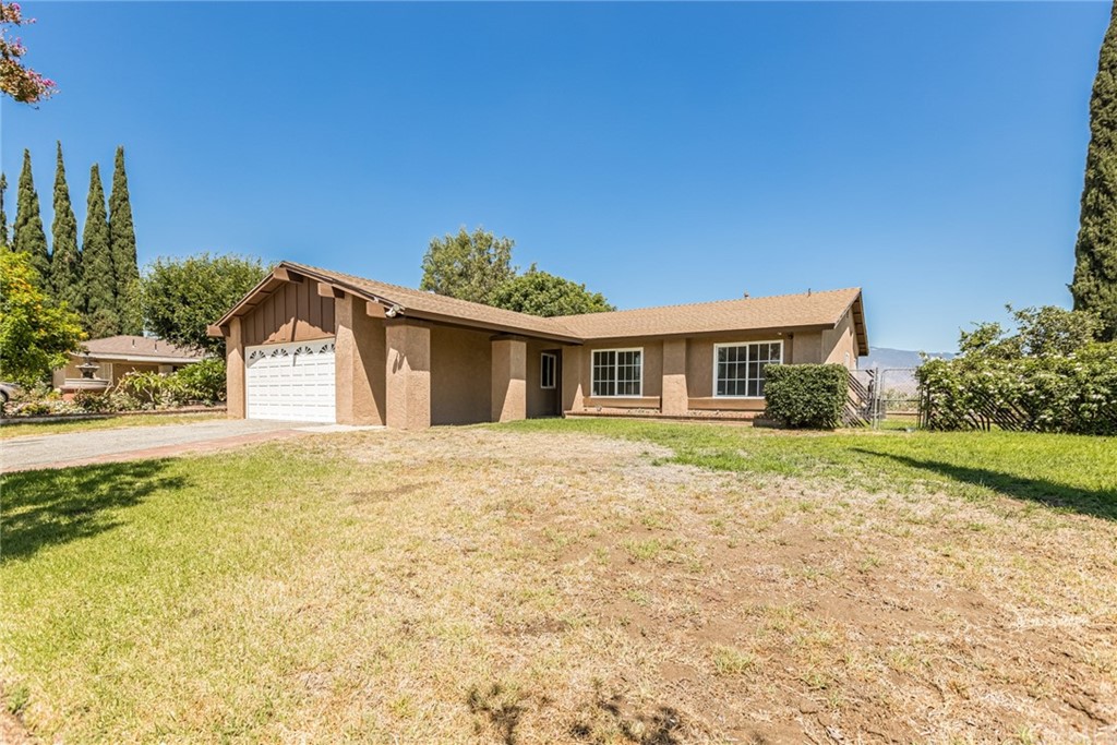 1221 Terrace Road Rialto, CA 92376 - Photo 1 of 1 a front view of a house with a yard and garage