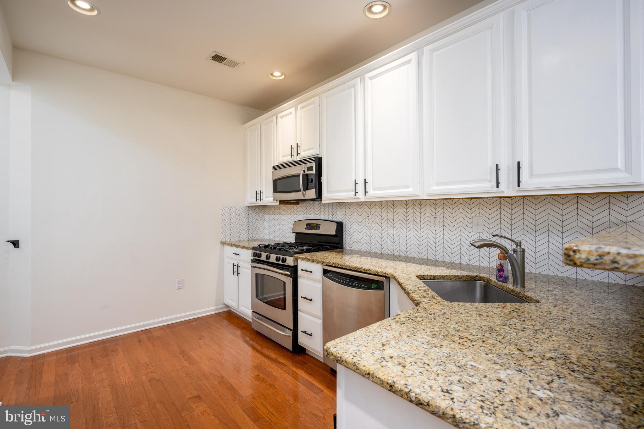 249 Concord Place Pennington, NJ 08534 - Photo 10 of 22 a kitchen with a sink a stove and cabinets