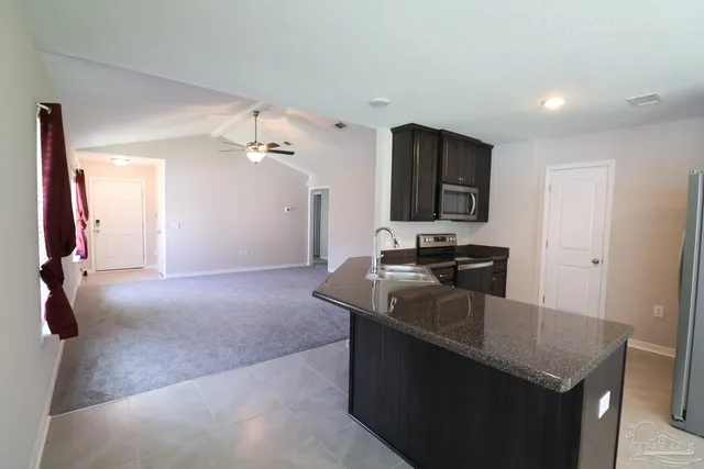 a kitchen that has a sink and a stove