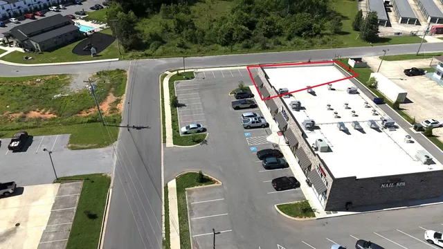 an aerial view of a residential house with an outdoor space