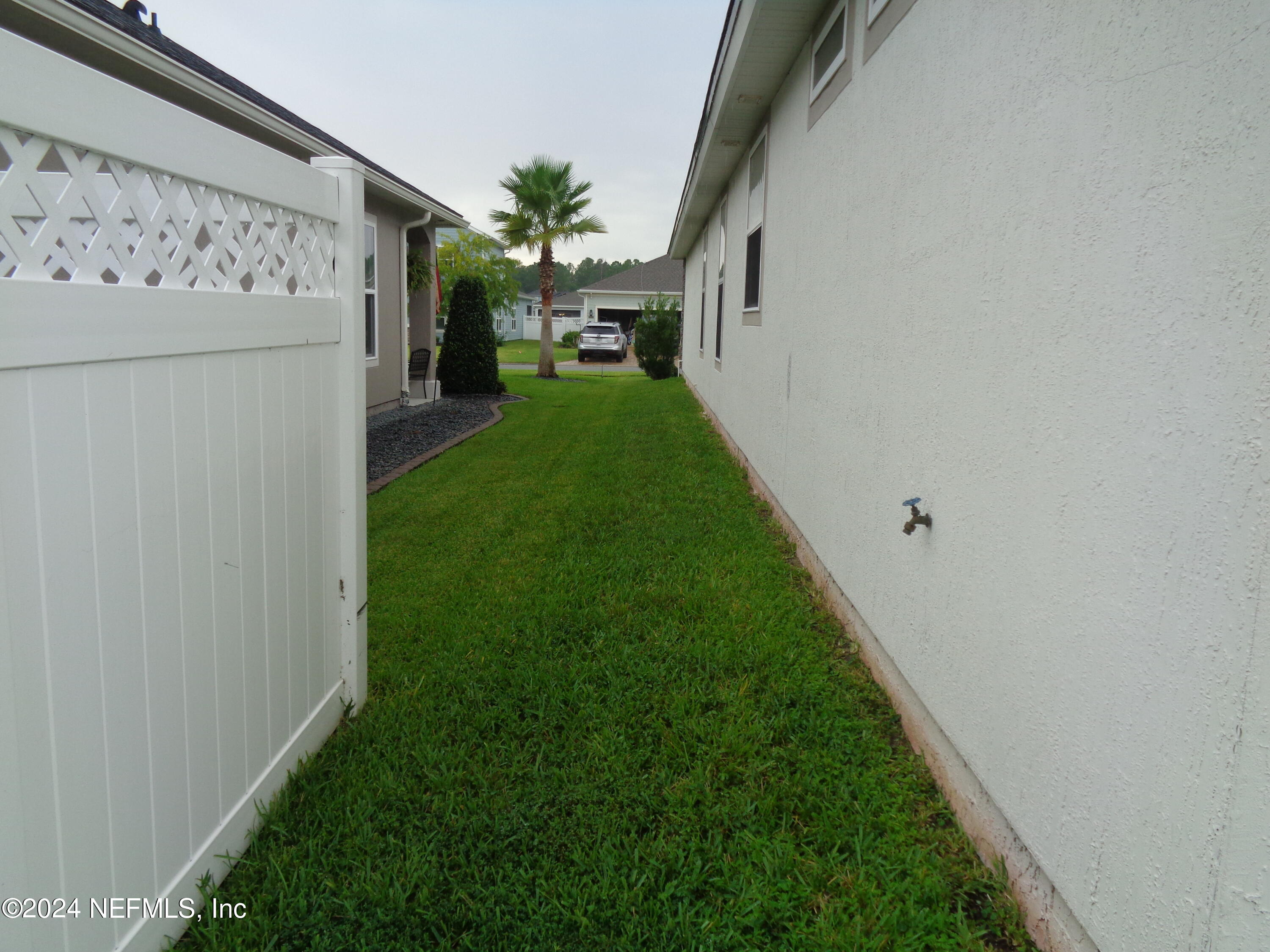 4055 Arbor Mill Circle Orange Park, FL 32065 - Photo 13 of 44 a view of a backyard with a white house