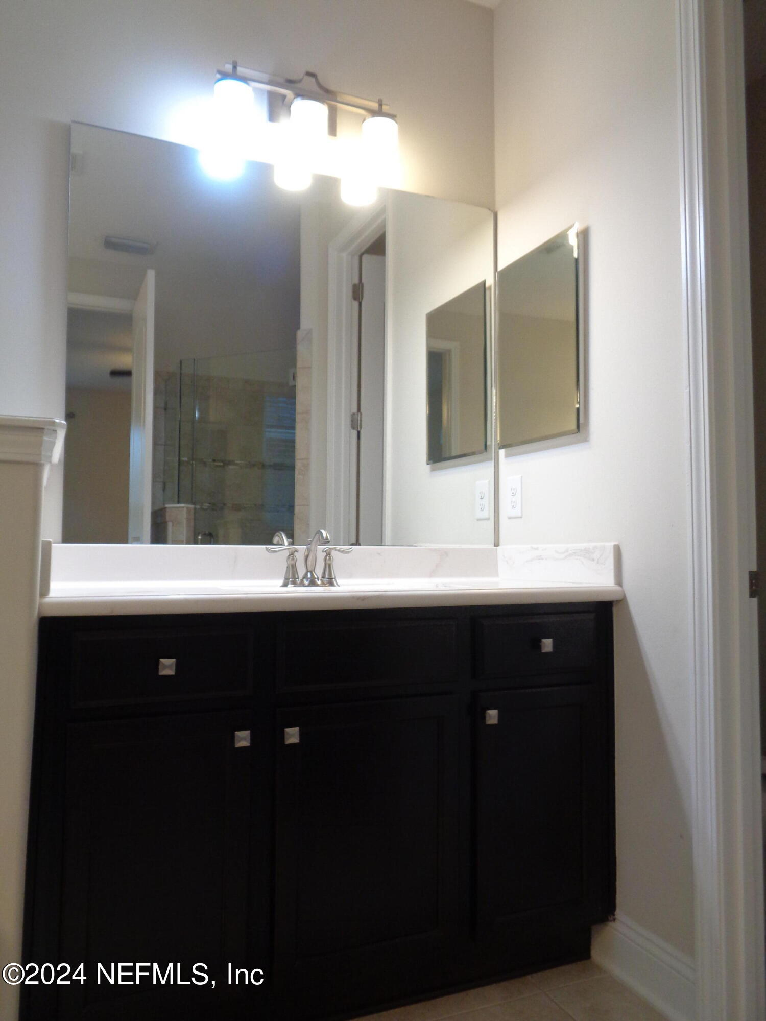 4055 Arbor Mill Circle Orange Park, FL 32065 - Photo 18 of 44 a bathroom with a sink and a mirror