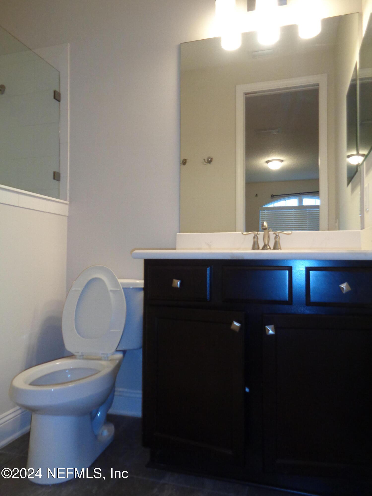 4055 Arbor Mill Circle Orange Park, FL 32065 - Photo 19 of 44 a bathroom with a toilet sink and mirror