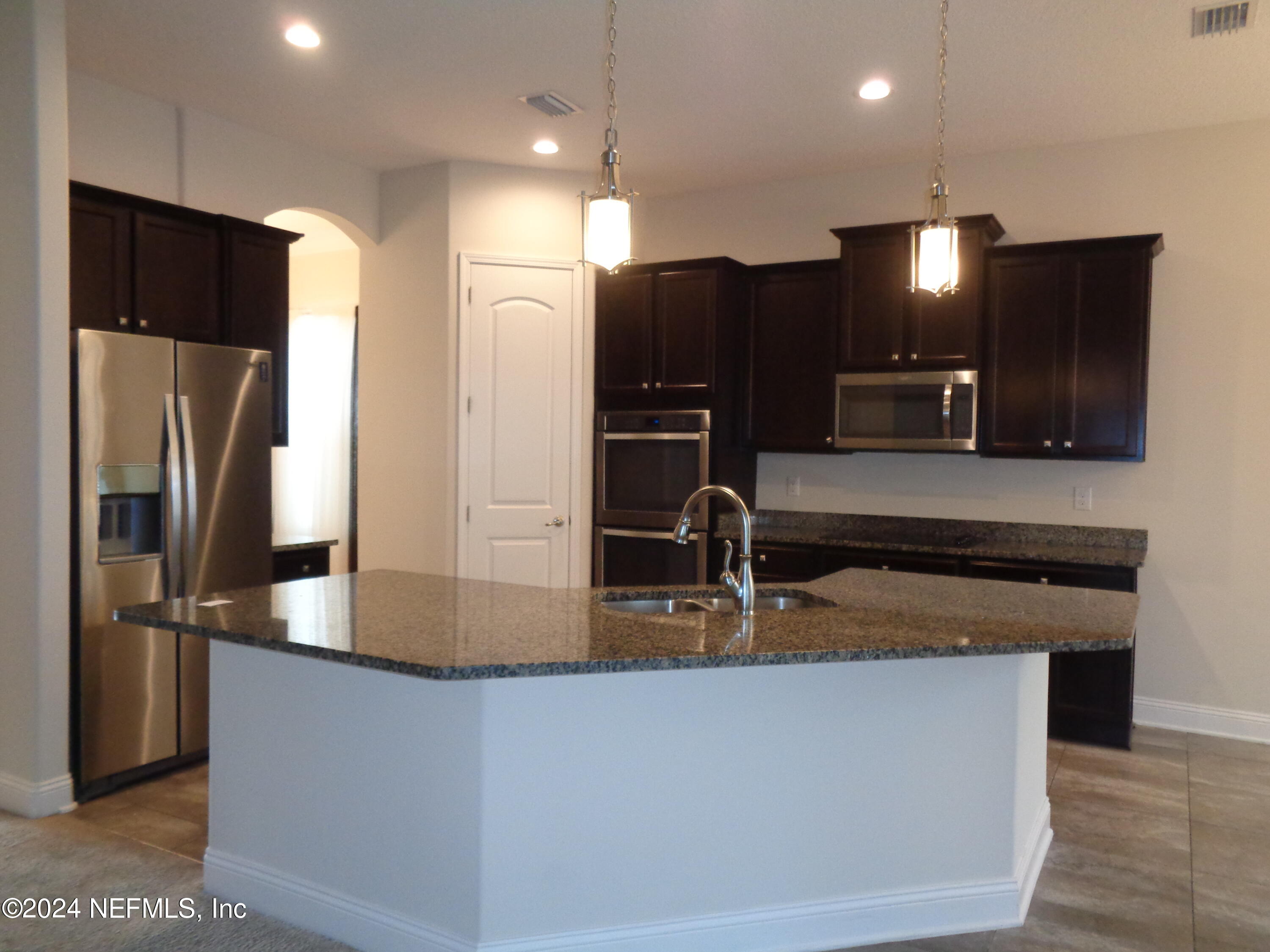 4055 Arbor Mill Circle Orange Park, FL 32065 - Photo 27 of 44 a kitchen with stainless steel appliances granite countertop a refrigerator and a sink