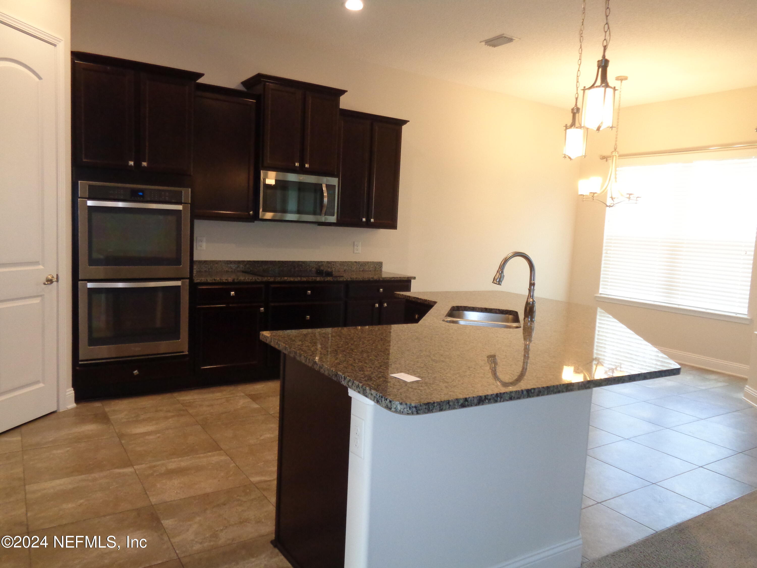 4055 Arbor Mill Circle Orange Park, FL 32065 - Photo 28 of 44 a kitchen with a sink and cabinets