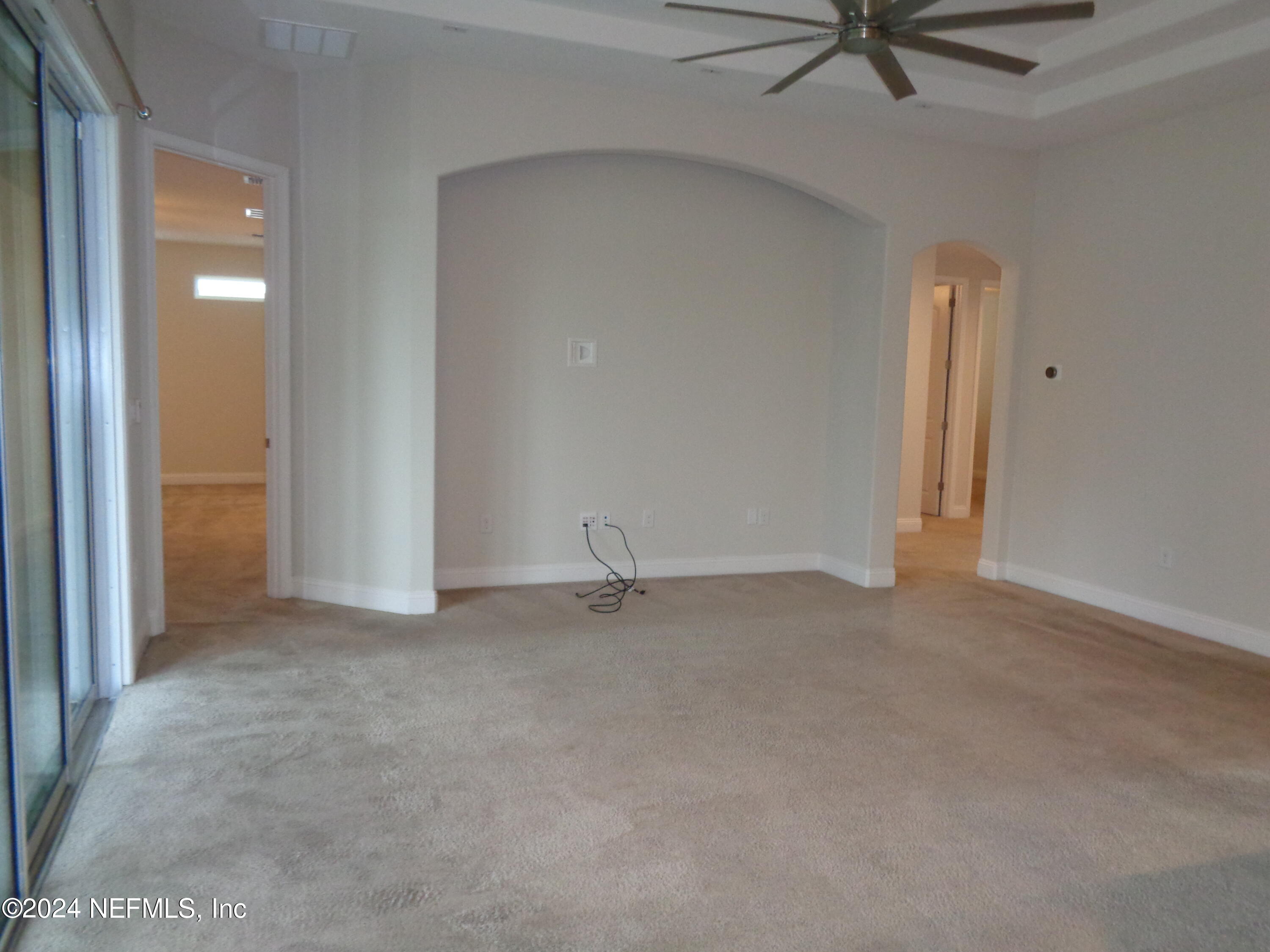 4055 Arbor Mill Circle Orange Park, FL 32065 - Photo 29 of 44 an empty room with a ceiling fan and window
