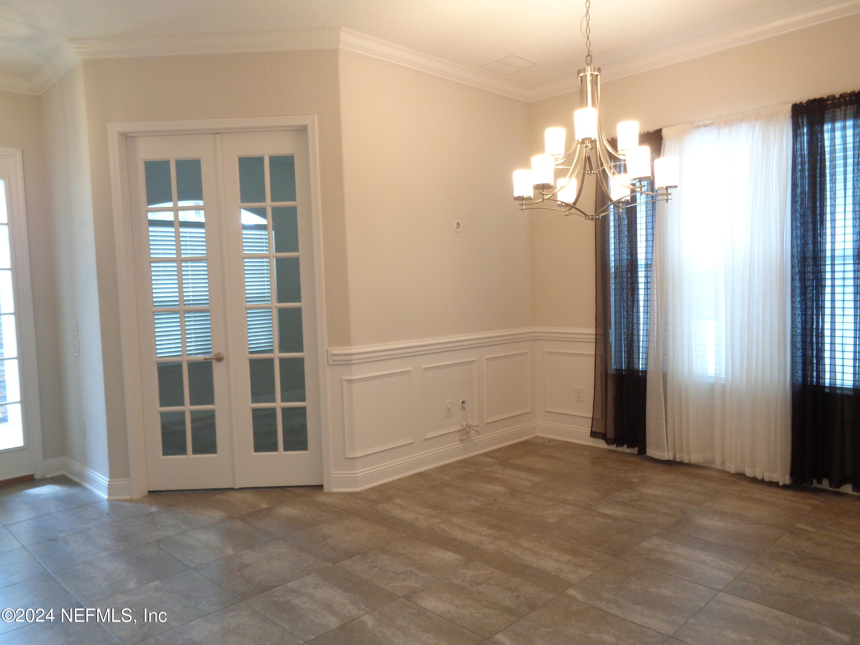 4055 Arbor Mill Circle Orange Park, FL 32065 - Photo 30 of 44 a view of a livingroom with a chandelier fan and windows