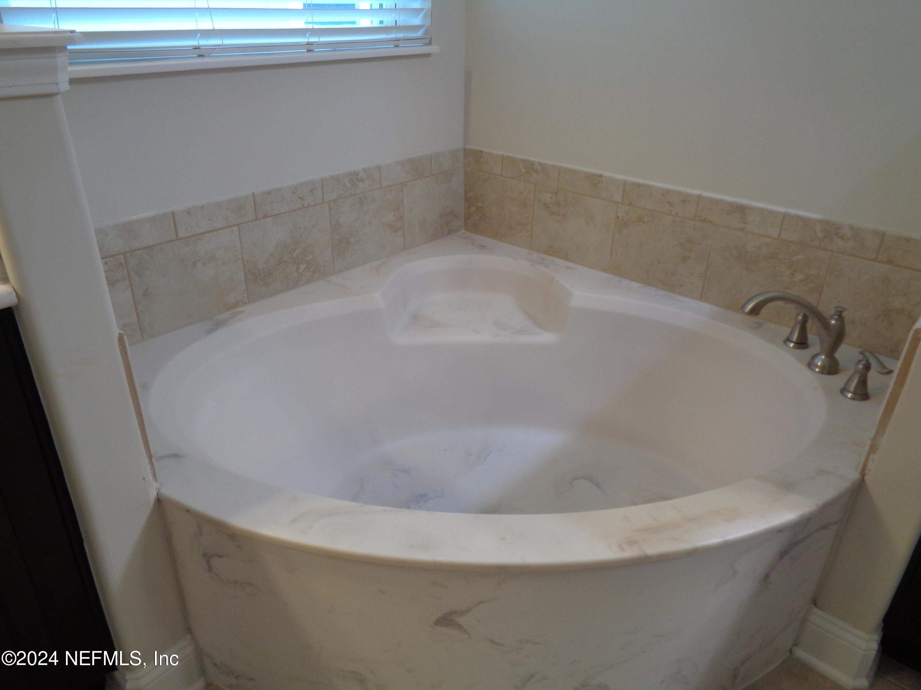 4055 Arbor Mill Circle Orange Park, FL 32065 - Photo 35 of 44 a white bath tub sitting in a bathroom