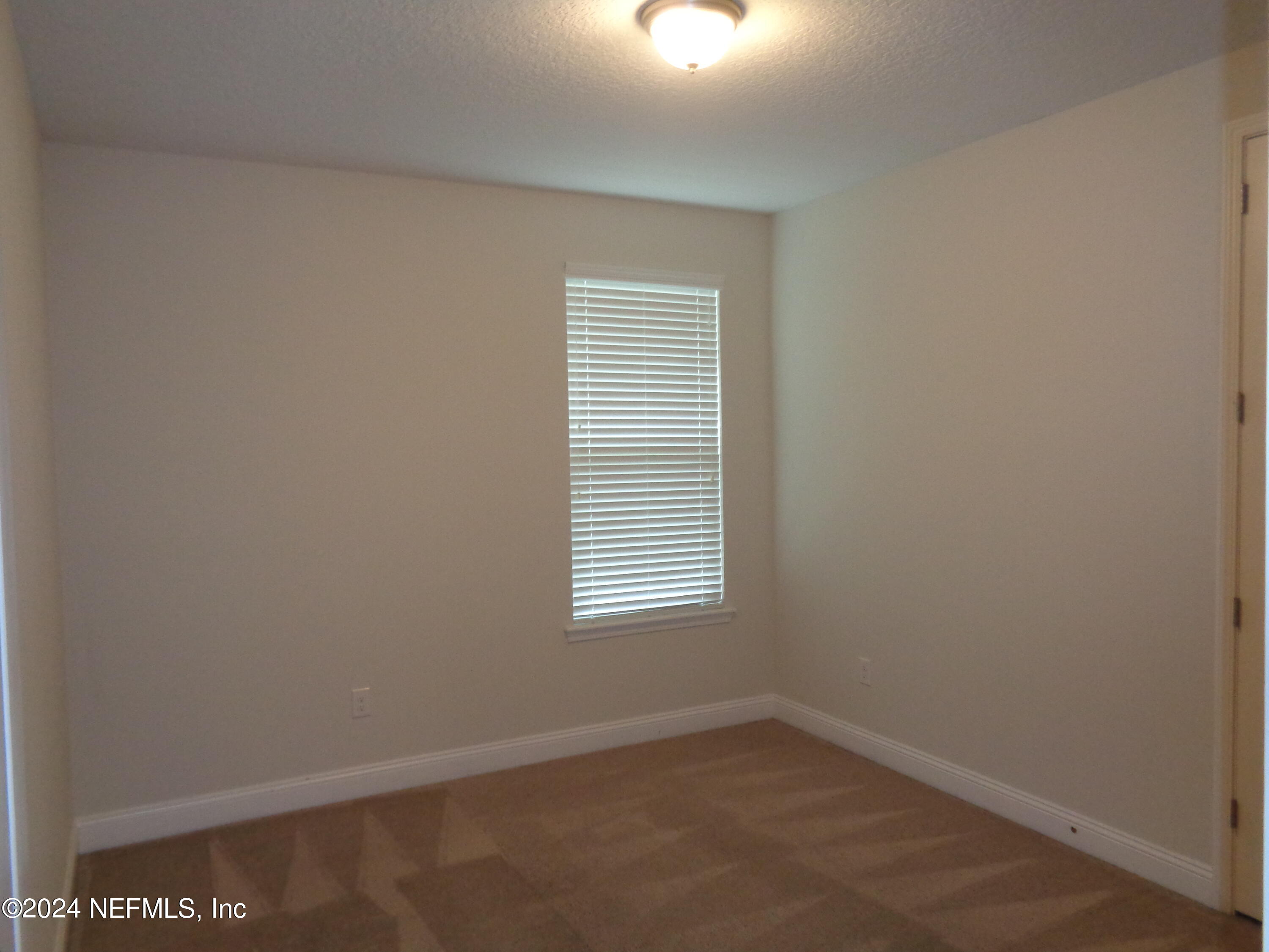 4055 Arbor Mill Circle Orange Park, FL 32065 - Photo 42 of 44 an empty room with a window