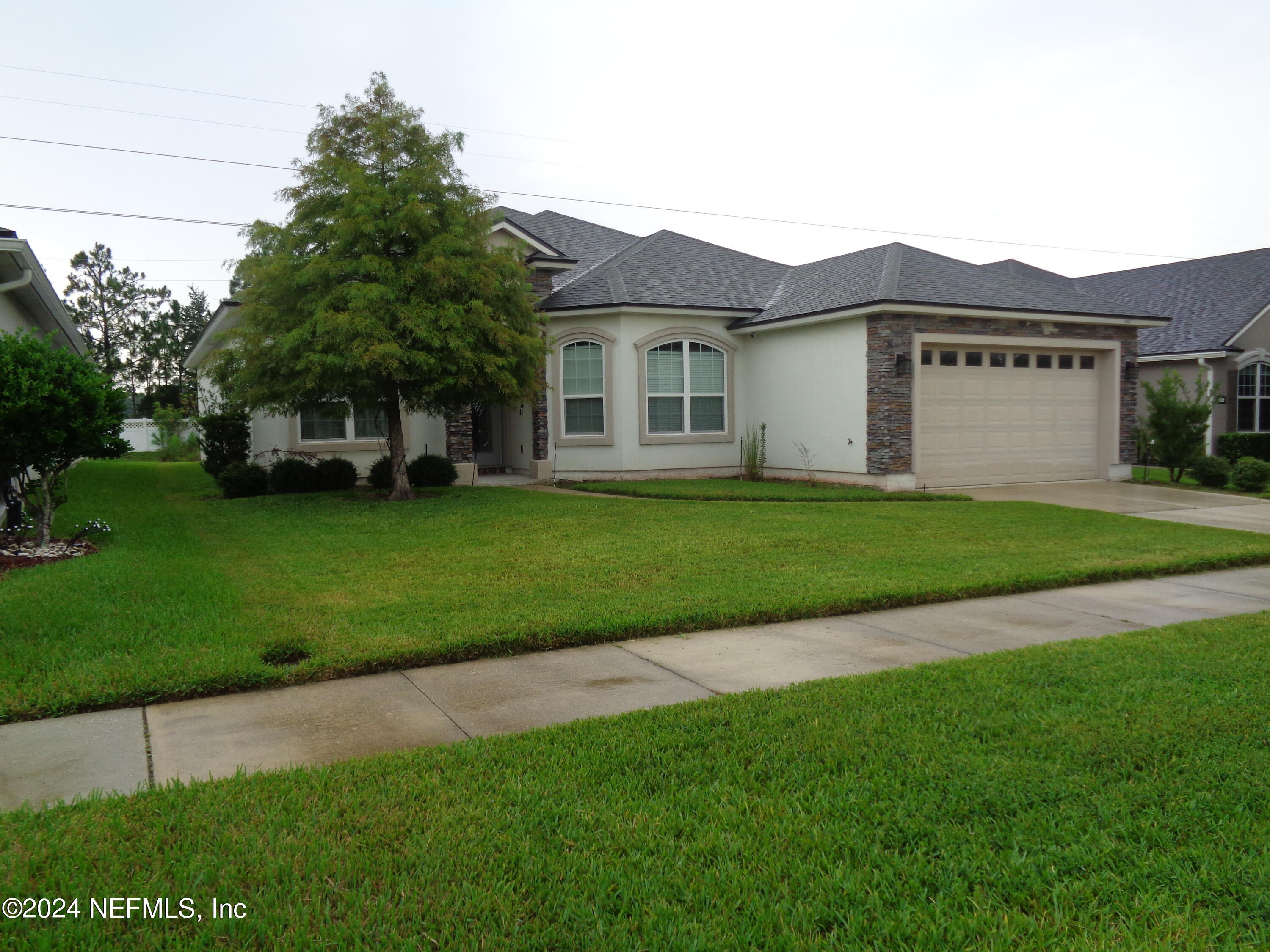 4055 Arbor Mill Circle Orange Park, FL 32065 - Photo 5 of 44 a view of a yard in front of a house