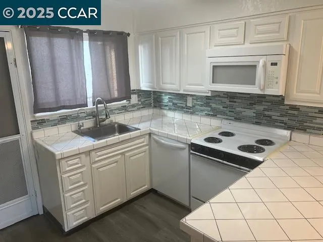 a kitchen with a sink cabinets and stainless steel appliances