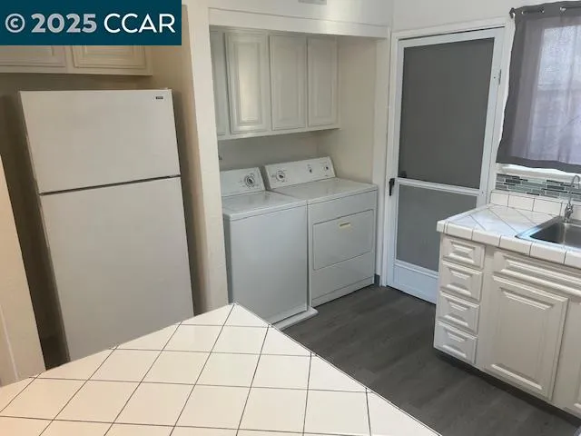 a utility room with sink washer and dryer