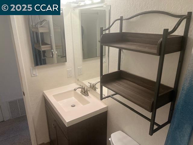 1851 Harrison Street, Unit 15 Concord, CA 94520 - Photo 32 of 41 a bathroom with a sink and mirror