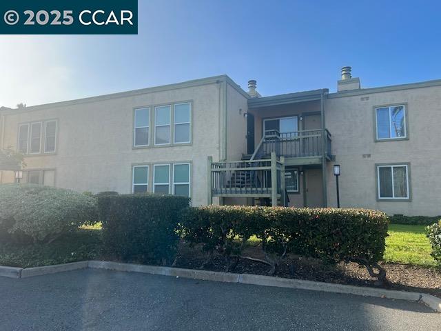 1851 Harrison Street, Unit 15 Concord, CA 94520 - Photo 4 of 41 a front view of a house with a yard