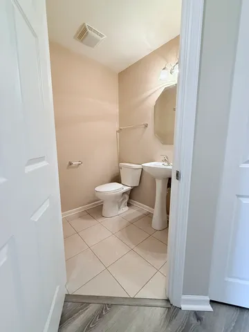 a bathroom with a toilet and a mirror