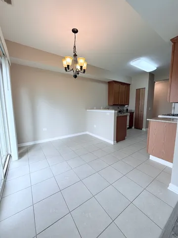 a view of a kitchen with a sink and a refrigerator