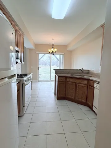 a kitchen with a sink a counter and cabinets