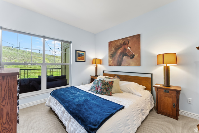 900 Bitner Road, Unit K25 Park City, UT 84098 - Photo 16 of 35 Bedroom featuring a large window, light-colored carpeting, and light blue walls