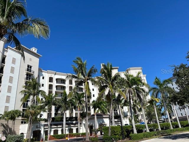 a view of multiple house with palm trees