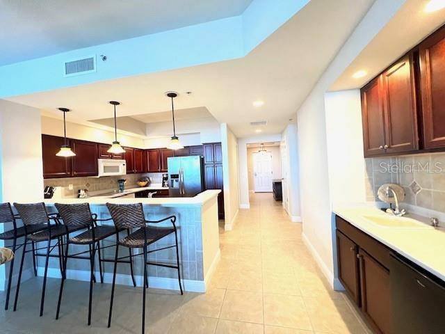 3321 Sunset Key Circle, Unit 502 Punta Gorda, FL 33955 - Photo 12 of 53 a open kitchen with stainless steel appliances kitchen island granite countertop a table chairs sink and cabinets