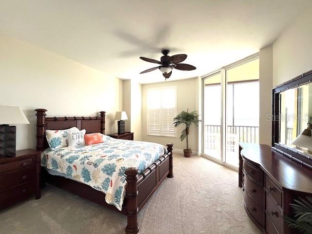 3321 Sunset Key Circle, Unit 502 Punta Gorda, FL 33955 - Photo 15 of 53 a bedroom with a large bed and a chandelier fan