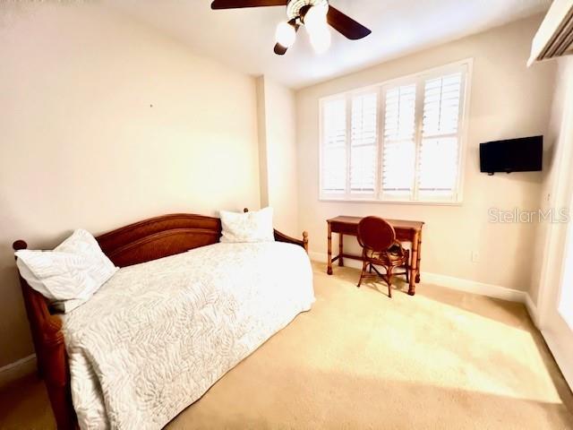 3321 Sunset Key Circle, Unit 502 Punta Gorda, FL 33955 - Photo 21 of 53 a bedroom with a bed and a table in it