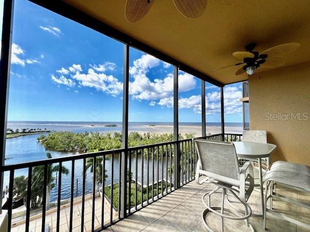 3321 Sunset Key Circle, Unit 502 Punta Gorda, FL 33955 - Photo 8 of 53 a view of a balcony dining table and chairs