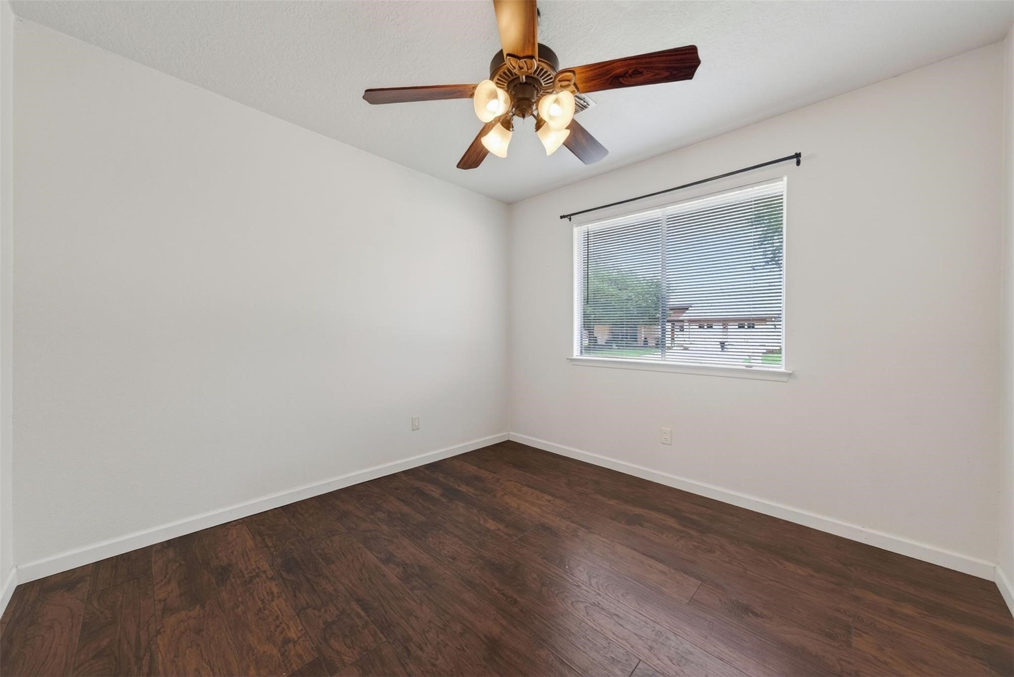 17002 Dew Drop Lane Houston, TX 77095 - Photo 16 of 24 an empty room with wooden floor and chandelier fan