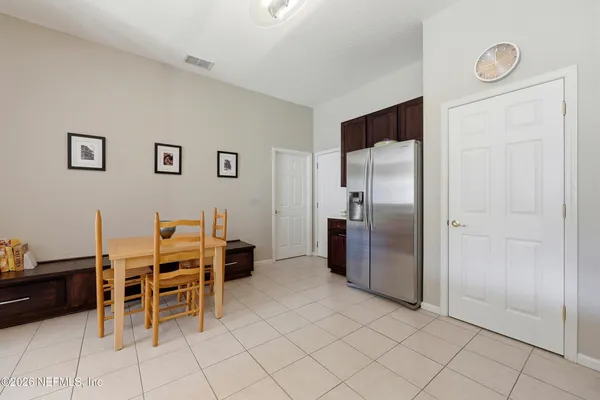 a view of a kitchen with furniture and refrigerator
