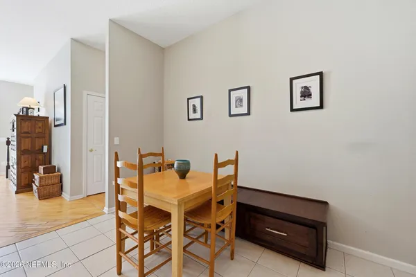 a view of a dining room with furniture and a potted plant