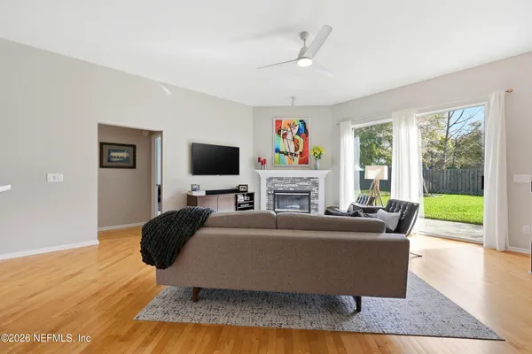 a living room with fireplace furniture and a flat screen tv