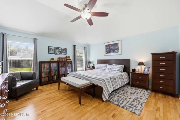 a spacious bedroom with a bed and a couch