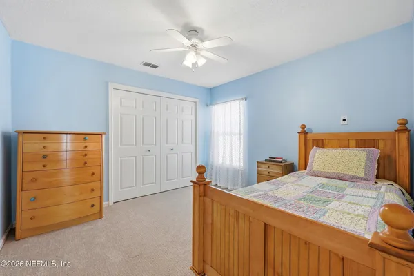 a bedroom with a bed and a dresser