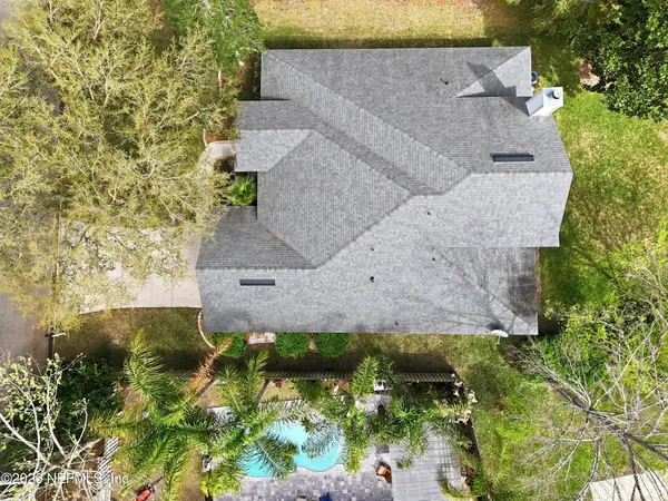 an aerial view of a house with a yard